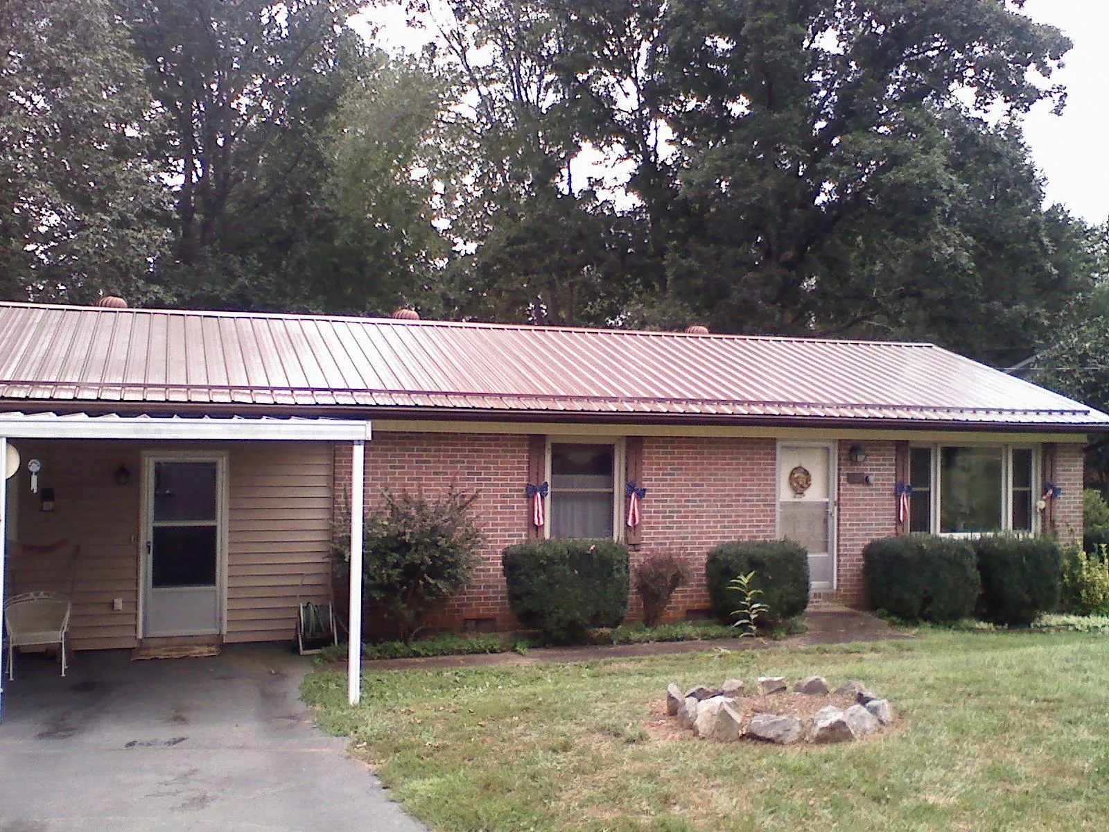 Bronze metal roof and carport on a brick ranch home — Roof Repair work by our crew in Selbyville
